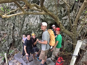 Sebastian with colleagues in a wooded area