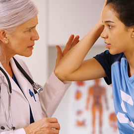 a couple of people standing next to a woman