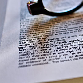 Close up image of glasses resting on a book