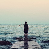 Photo of person looking out to sea