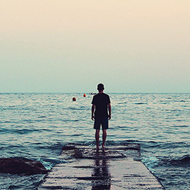 Photo of person looking out to sea