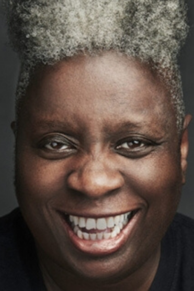 a man wearing glasses and smiling at the camera