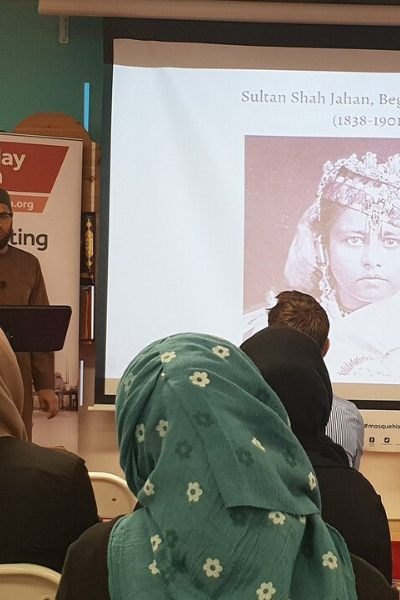 a person sitting in front of a store