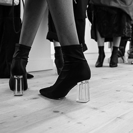 a group of people standing on a sidewalk