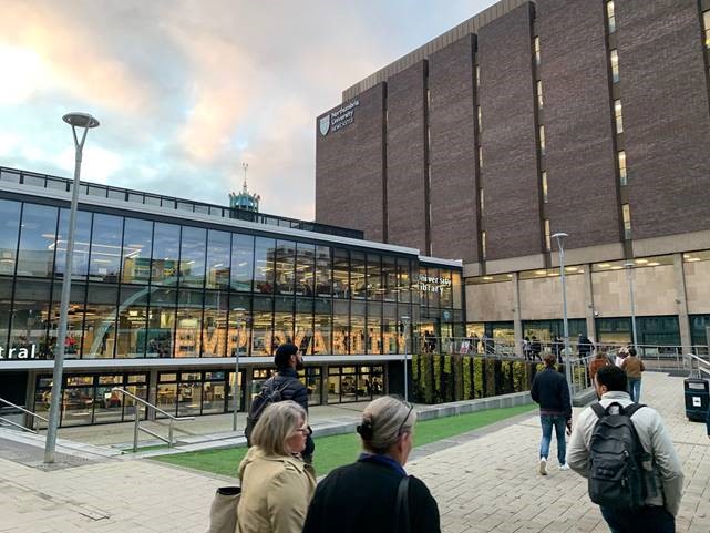 a group of people standing in front of a building