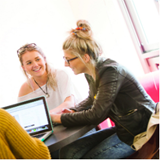 a group of people sitting at a desk