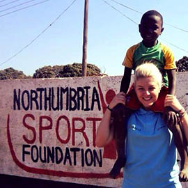 a man holding a sign posing for the camera