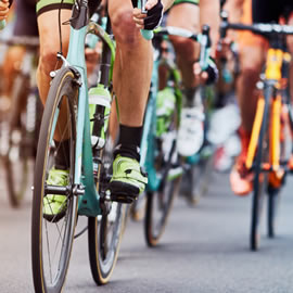 a group of people riding on the back of a bicycle