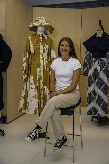 Caption: Fashion graduate Holly Hooker with her yellow outfit inspired by traditional smock frocks.