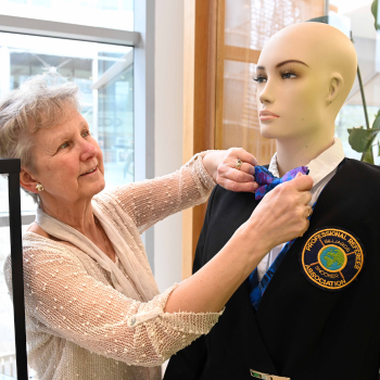 Caption: Diane Greaves admires some of the items on display at the Vera Selby exhibition.
