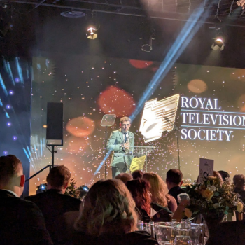 Caption:Will Croston receives his award on stage at the RTS regional awards