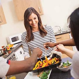 a woman preparing food in a kitchen