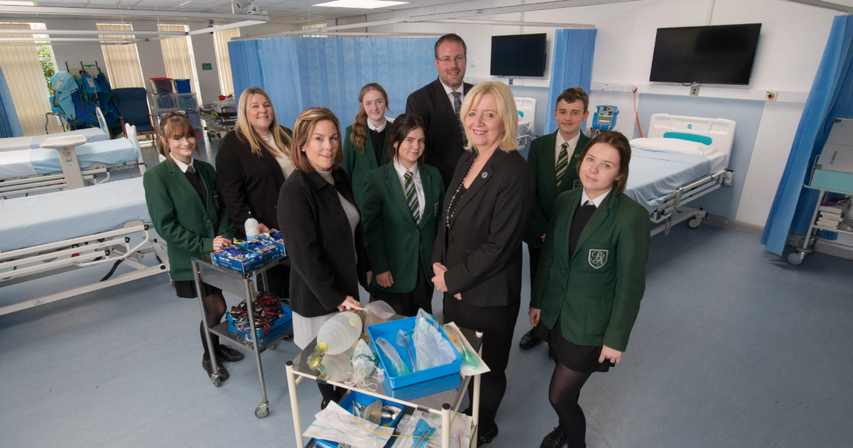 From left to right: Natalie Winchester, Subject Lead Health and Social Care and Post-16 Raising Standard Leader at Bede Academy, Dr Julie Derbyshire – Director of Apprenticeships and Assistant Professor in Nursing at Northumbria University, Andrew Thelwell – Principal at Bede Academy, Professor Alison Machin, Head of Department of Nursing, Midwifery and Health at Northumbria University and pupils from Bede Academy. 