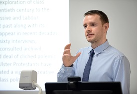 a man standing in front of a computer