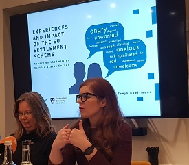 a woman holding a sign