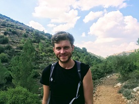 a man standing on a dirt road