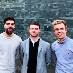 a man standing in front of a group of people posing for the camera