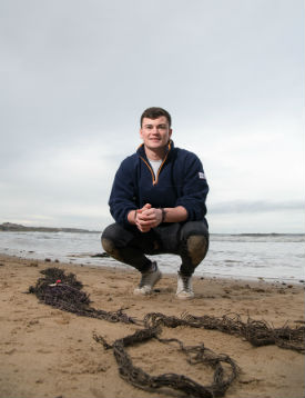 a man standing on top of a sandy beach