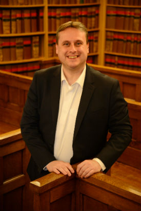 a person standing in front of a book shelf