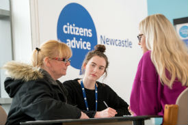 a group of people standing next to a woman