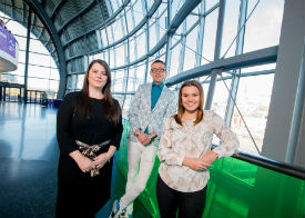 a man and a woman standing in front of a window