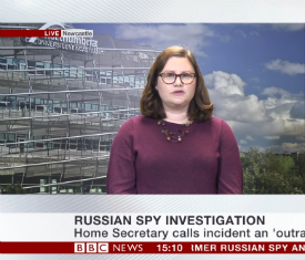 a person standing in front of a television