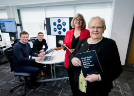 a group of people standing around a table