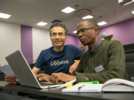 a group of people looking at a computer