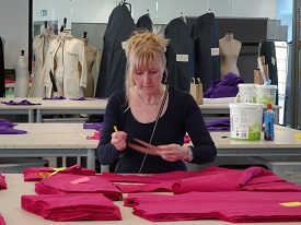 a woman cutting a cake