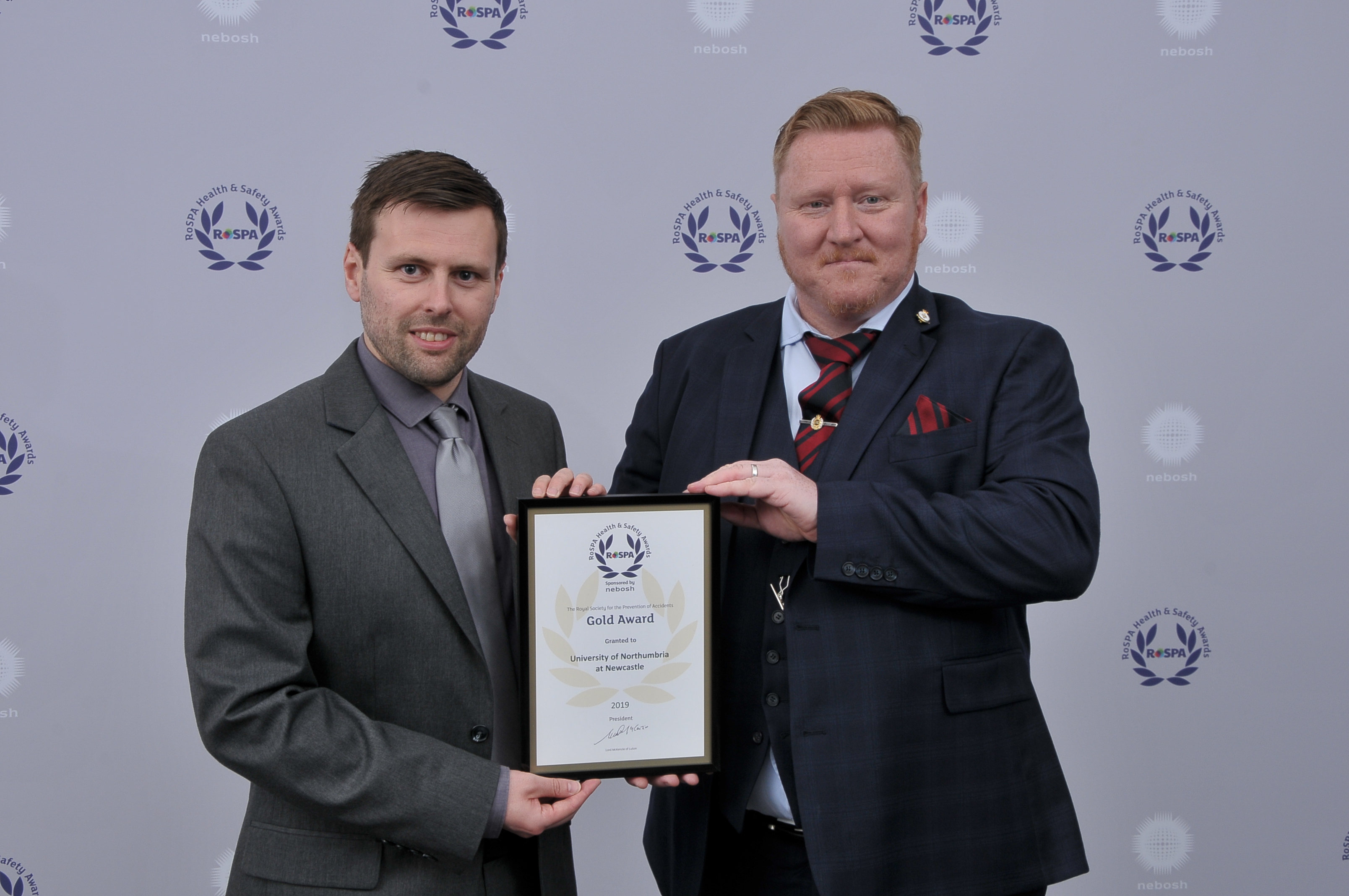 a man holding a sign posing for the camera