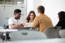 Image of four students sitting together at a desk
