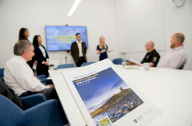 a group of people sitting at a desk