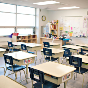 an office with a desk and chair in a room