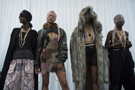 a group of people standing in front of a coat