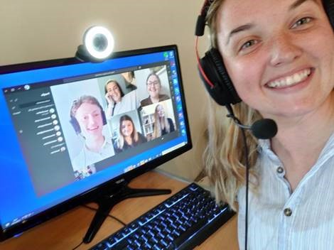 a woman posing in front of a computer