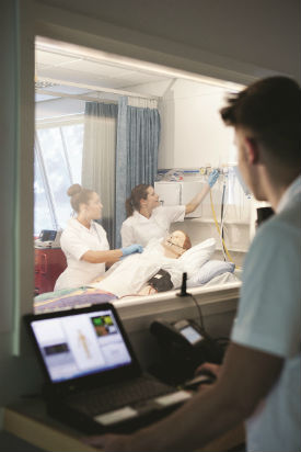 a group of people looking at a computer