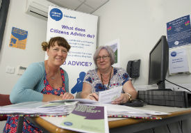 a group of people sitting at a desk