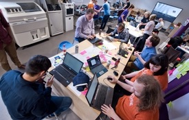a group of people looking at a laptop