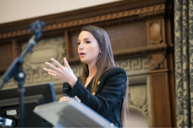 a woman standing in front of a mirror posing for the camera