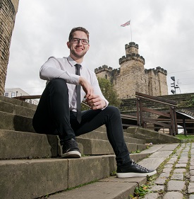 a man sitting on a statue of a cement bench
