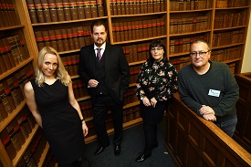 a group of people standing in a library