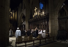 a group of people walking down a street next to a building