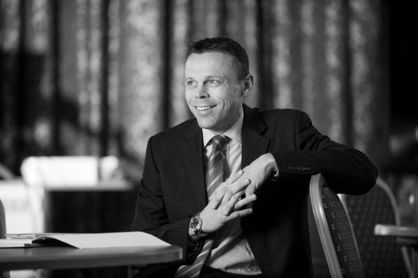 a man sitting in a chair talking on the phone