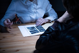 a person sitting at a table using a laptop