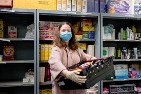 a person standing in front of a book shelf