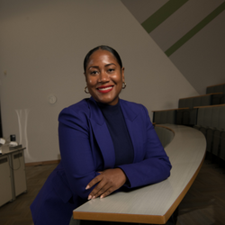 Stephanie L. Young pictured in a lecture theatre smiling at the camera