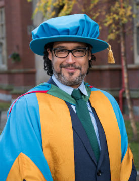 David Olusoga wearing a hat