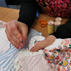 Mothers working on the quilts at the community workshops hosted by the researchers.