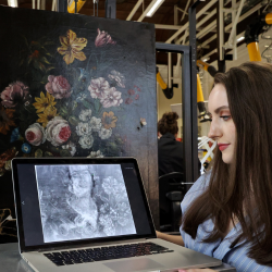 a student looking at a painting