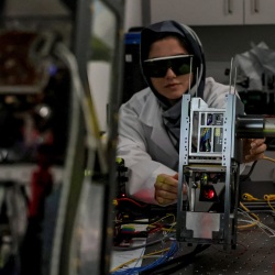 Northumbria's Dr Rida Zia-ul-Mustafa, Postdoctoral Research Associate in Free-Space, pictured testing one of the CubeSats.